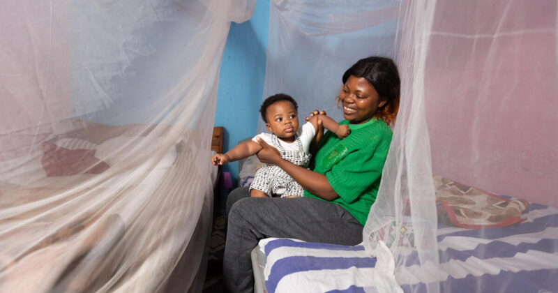 Tony-Jason, 8 months old, and his mother, Melissa, playing together in their home in Soa. Their family sleeps under new dual AI insecticide-treated mosquito nets to protect themselves from malaria. The Global Fund supports the procurement and distribution of mosquito nets across Cameroon.