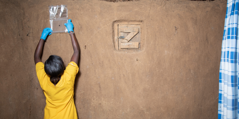 Photo: Unitaid Community health worker installing a spatial emanator.